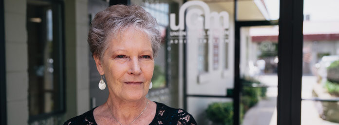 woman with short gray hair smiling