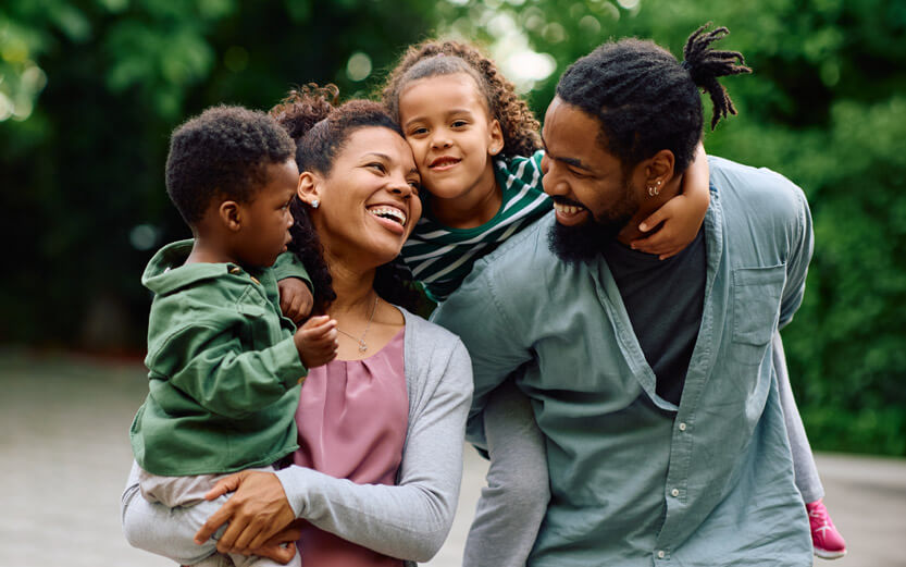 a family of four laughing together