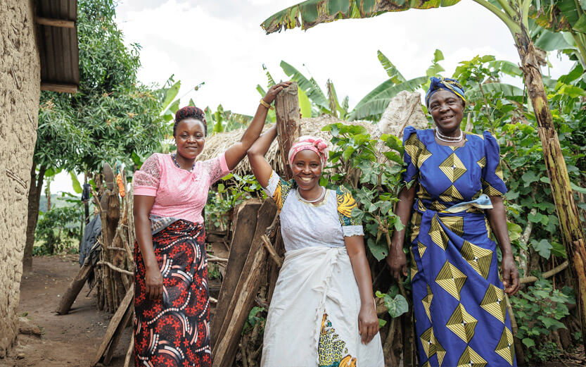 three women outside smiling
