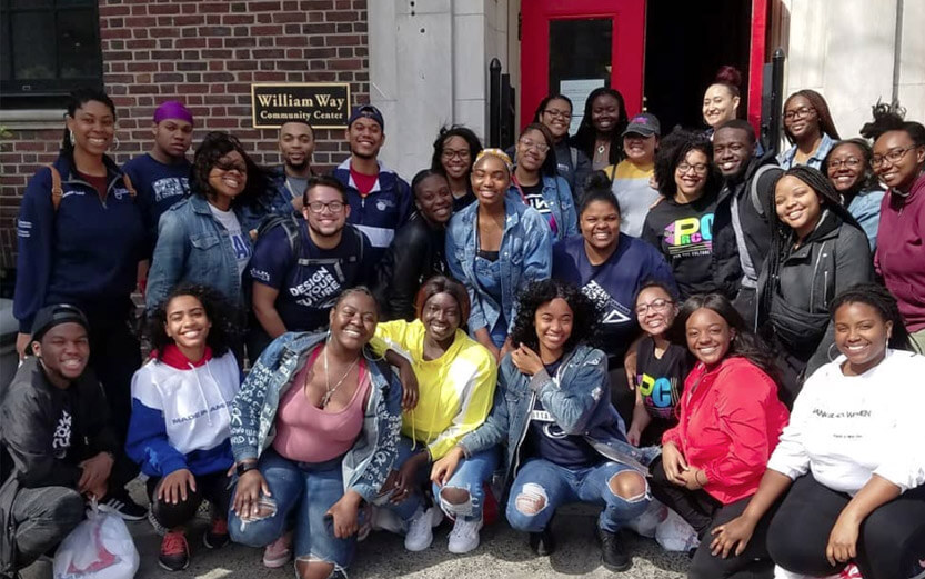 a group of people pose for a group photo in front of the William Way community center