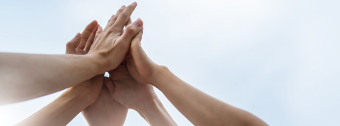 five hands doing a group hi-five
