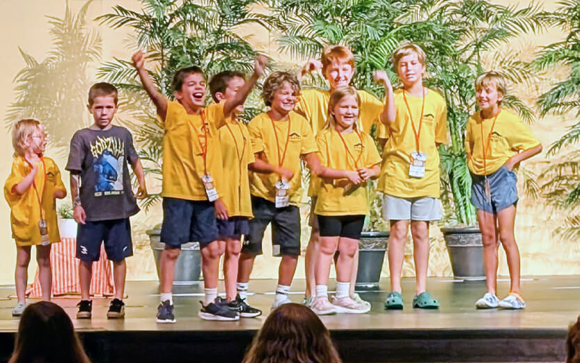 a group of young kids on stage performing a play