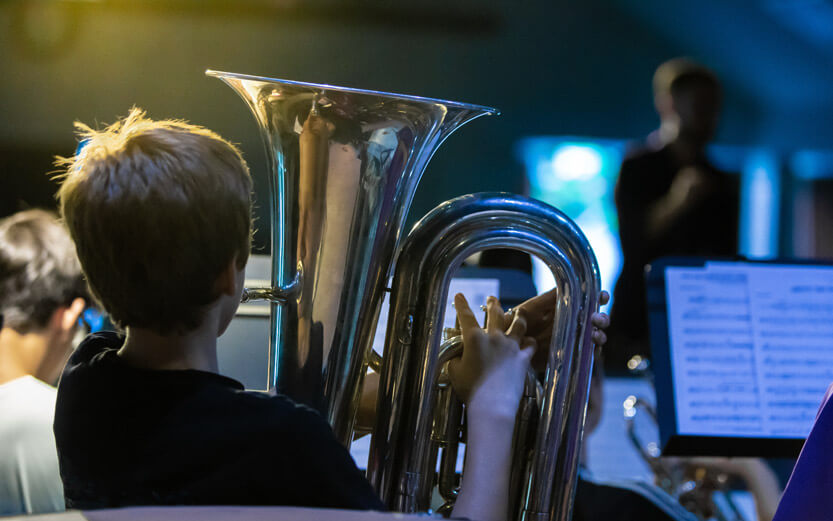 view from behind of a boy playing a barritone