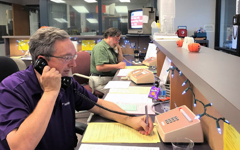 volunteers taking calls at the radio station