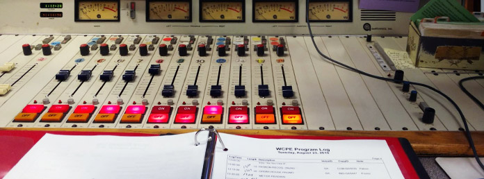 close up of an audio panel and a WCPE program log
