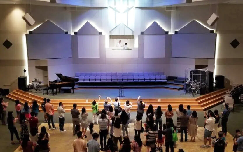 a baptism being performed in front of the congregation