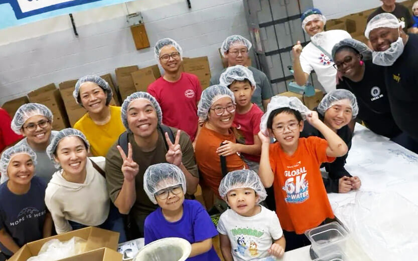 a group of people wearing hair nets while doing service work at a kitchen