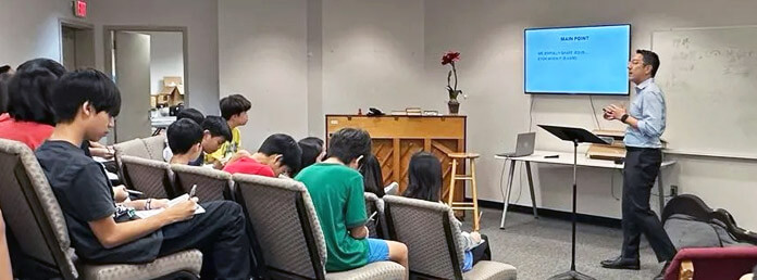 a church instructor in the classroom teaching students