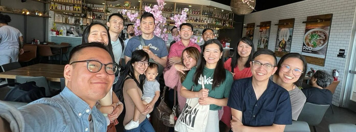 a group of people at a restaurant taking a selfie