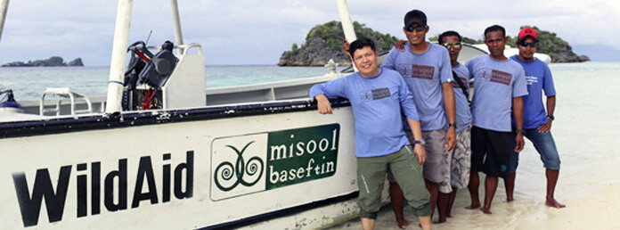 five WildAid workers with boat